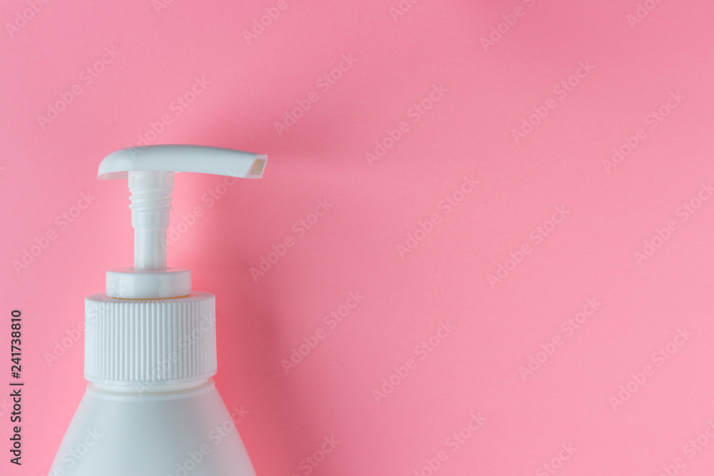 Bathroom skincare accessory, white soap pump bottle close-up photo on pink background. Copy space Bathroom skincare accessory, white soap pump bottle close-up photo on pink background. Copy space