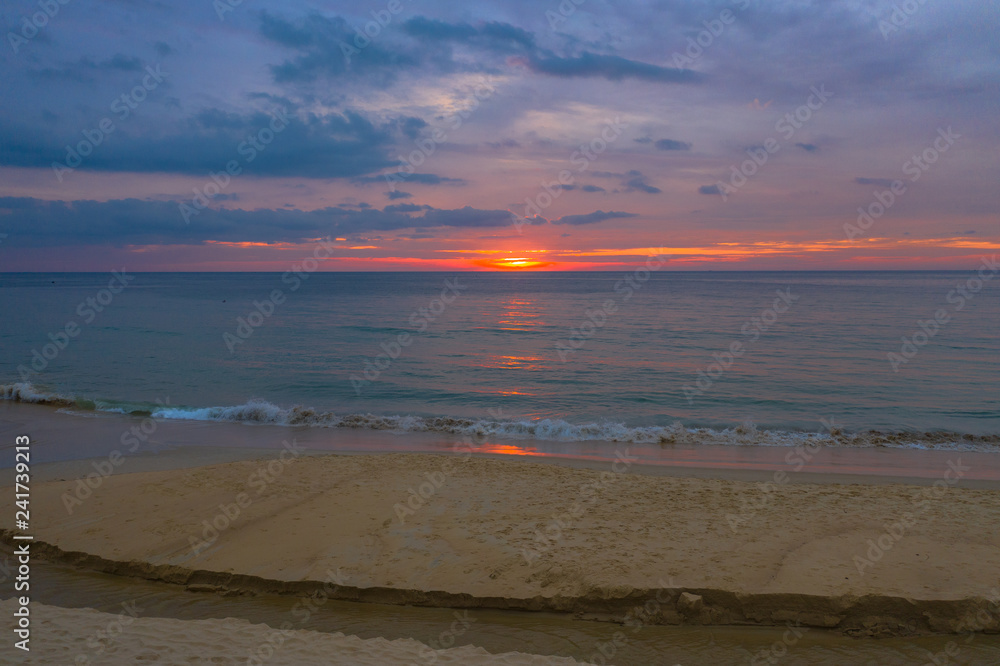 Obraz premium reflection of red sunset above the sea at Karon beach