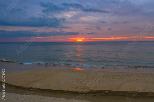 reflection of red sunset above the sea at Karon beach