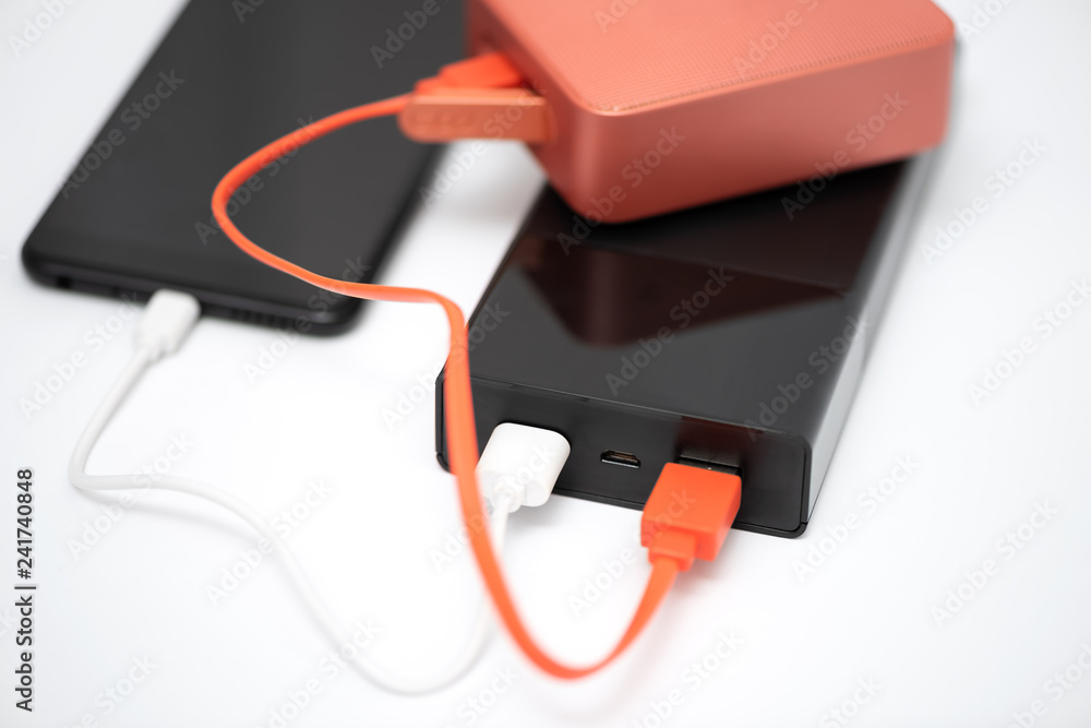 Power bank, bluetooth speaker and smartphone. Power bank, bluetooth speaker and smartphone.