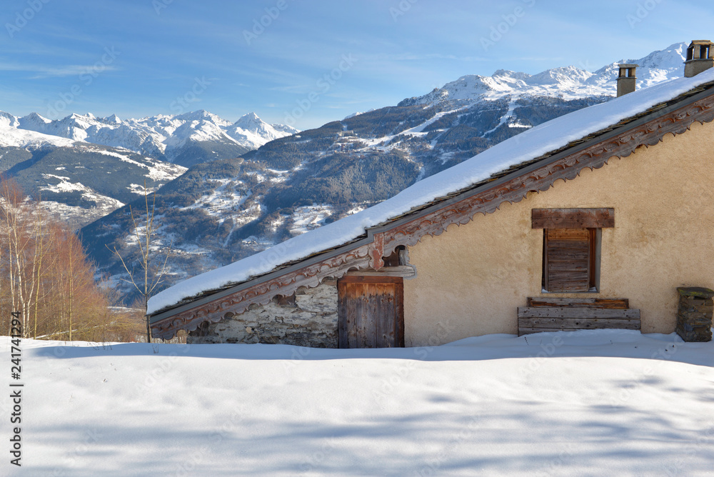 traditional alpine french cottage in mountain under the snow