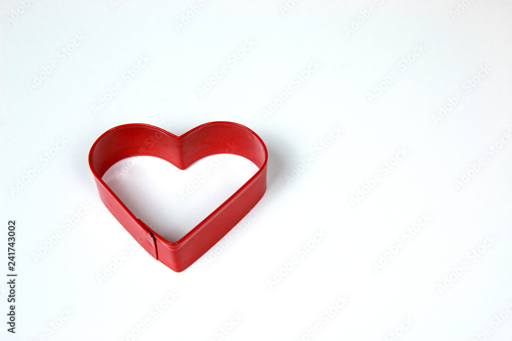Red Metal Heart Shaped cookie Cutter isolated on White background Red Metal Heart Shaped cookie Cutter isolated on White background