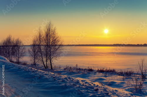 Fototapeta Naklejka Na Ścianę i Meble -  Winter rural landscape at sunrise. Sunrise over the snowy field