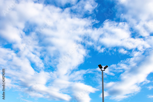 Street lamps with bright blue sky.