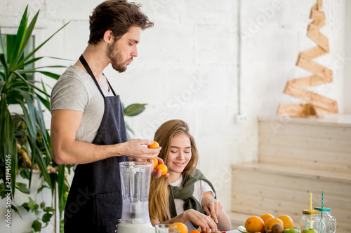 a couple making yogart with fruits. close up photo. copy space. creation of fruit juice beverage photo