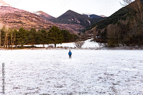 LLittle boy alone on a snowy field