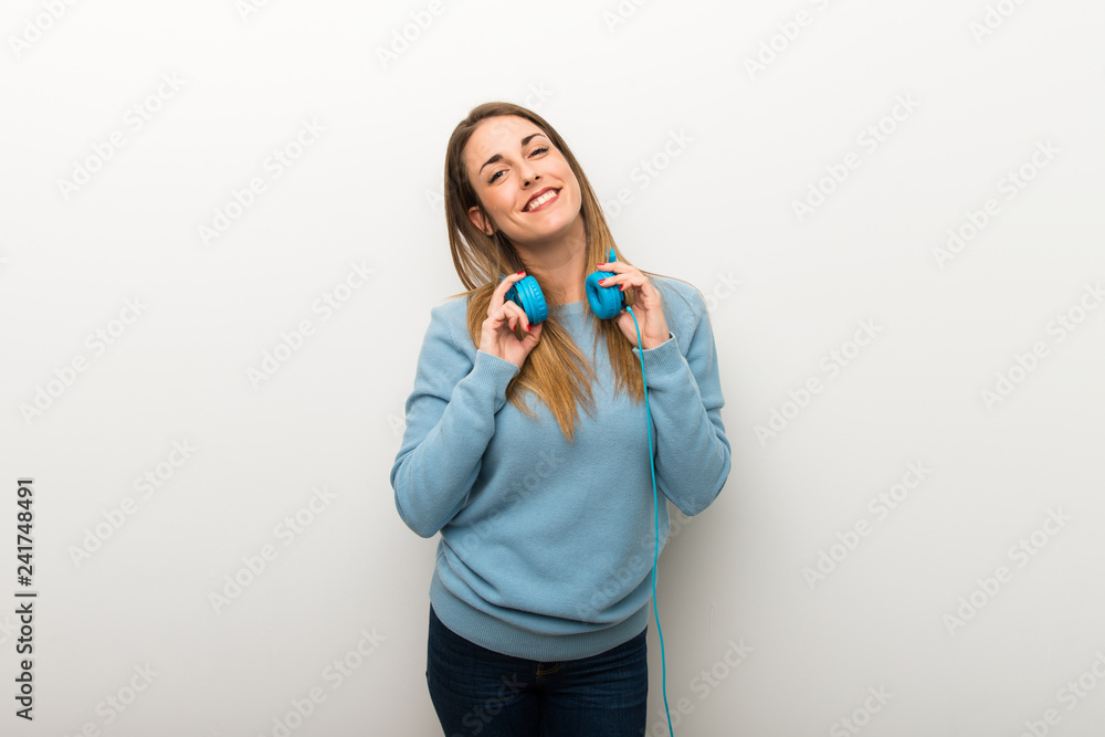 Blonde woman on isolated white background with headphones Blonde woman on isolated white background with headphones