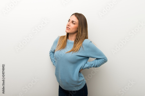 Blonde woman on isolated white background suffering from backache for having made an effort