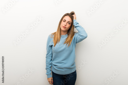 Blonde woman on isolated white background with an expression of frustration and not understanding