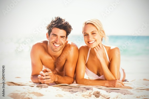 Young couple lying on beach © vectorfusionart