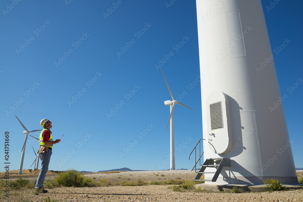 Side view of engineer standing in field against clear blue sky Side view of engineer standing in field against clear blue sky