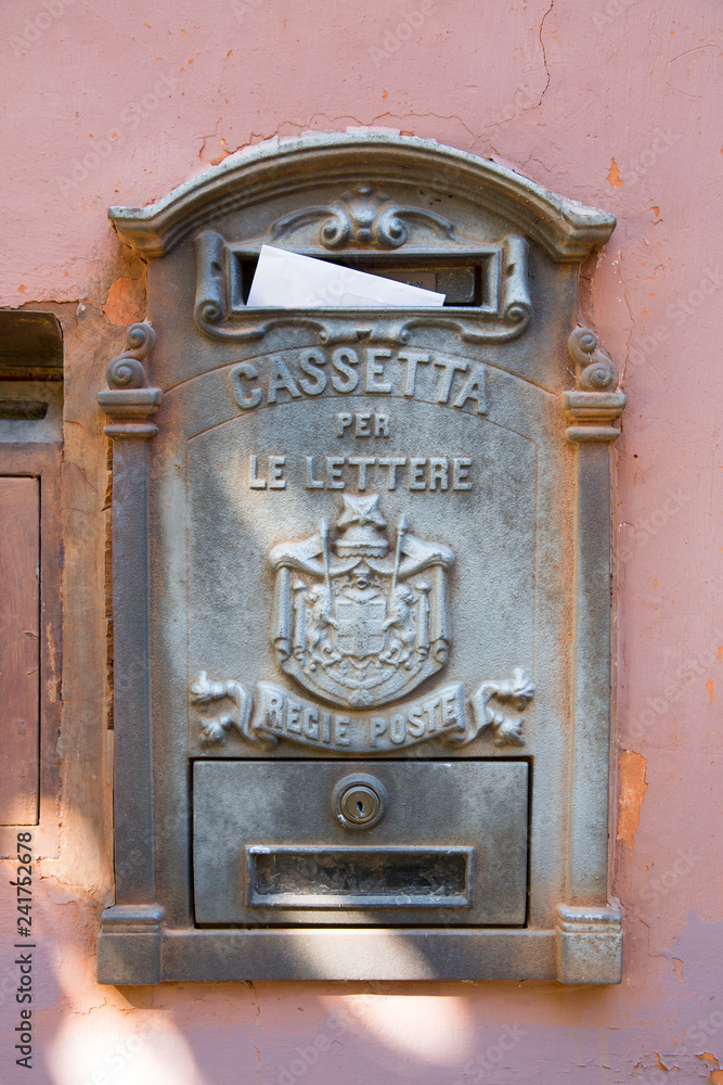 Vintage Italian mailbox (Cassette per le Lettre) with white envelope on a  light red plastered wall. Stock Photo | Adobe Stock