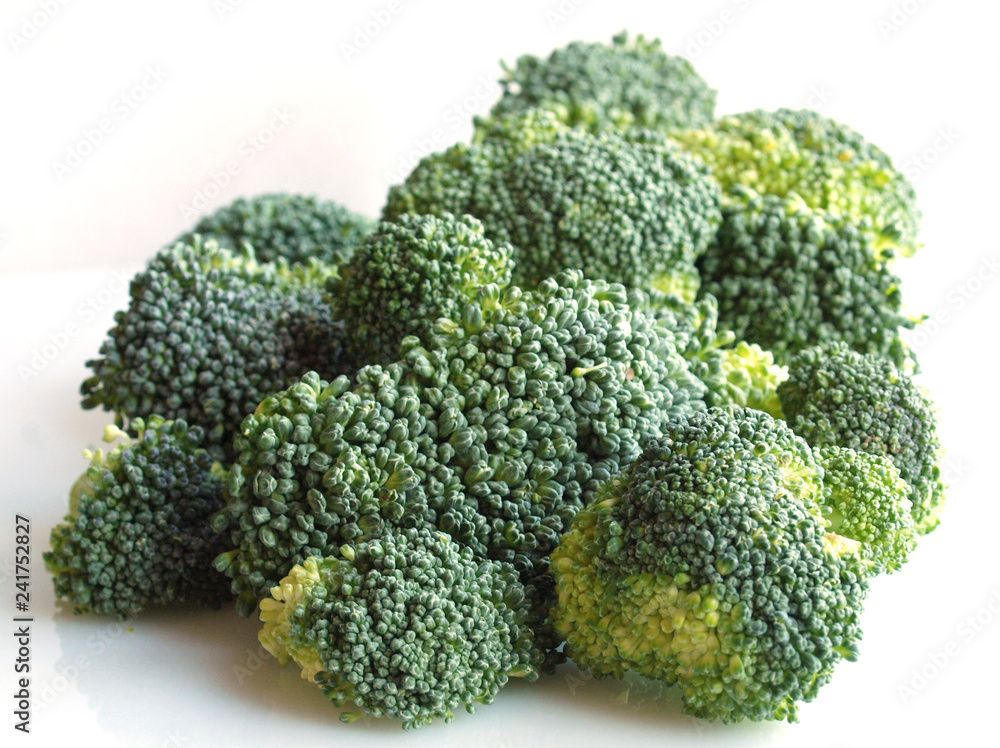 vegetables: brunch of green broccoli flowers over white background vegetables: brunch of green broccoli flowers over white background