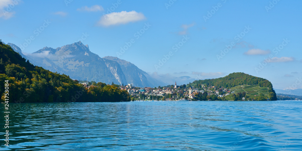 Panorama view of Lake Thun with Spiez town on the shore in the Bernese Oberland region in Switzerland.