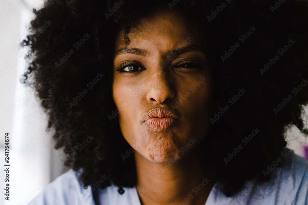 Portrait of young woman making facial expressions Portrait of young woman making facial expressions