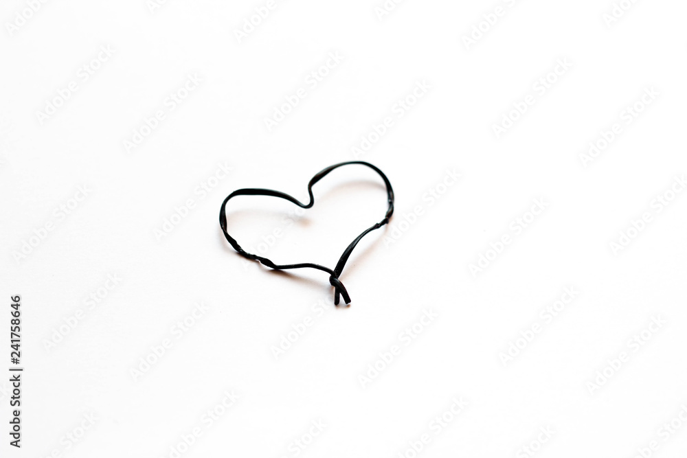 Black heart of wire on a white background. Valentine's Day. Black heart of wire on a white background. Valentine's Day.