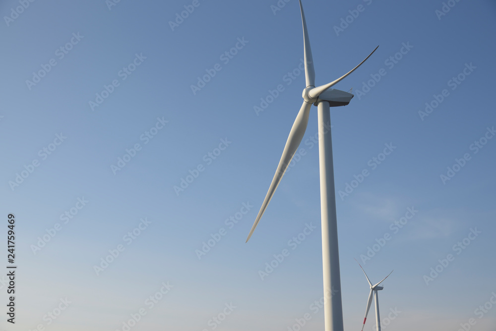 Green energy. Wind turbines at sunset for the production of renewable energy. Trentino, Italy Green energy. Wind turbines at sunset for the production of renewable energy. Trentino, Italy