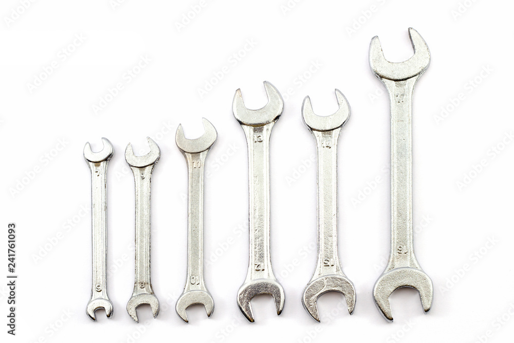 Silver coloured spanners lying side by side in white background Silver coloured spanners lying side by side in white background