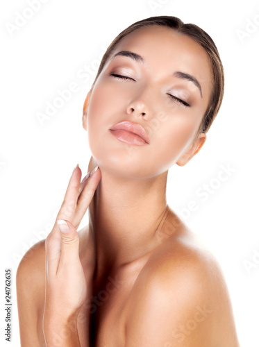 Young pretty woman with clean and fresh skin posing against white background, isolated