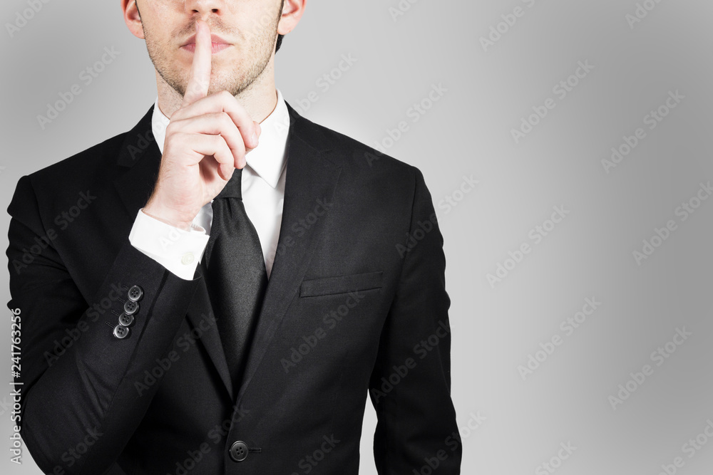 businessman in large empty office with finger on lips asking for silence 3d illustration businessman in large empty office with finger on lips asking for silence 3d illustration