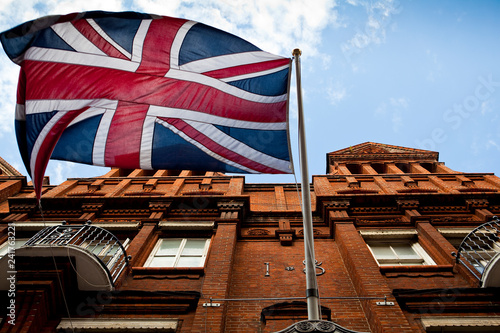 A british flag flies high above the streets of london.