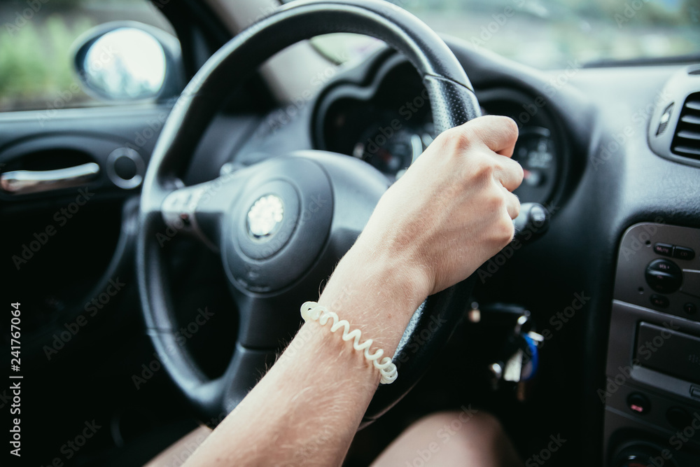 Sports car steering wheel, woman is driving