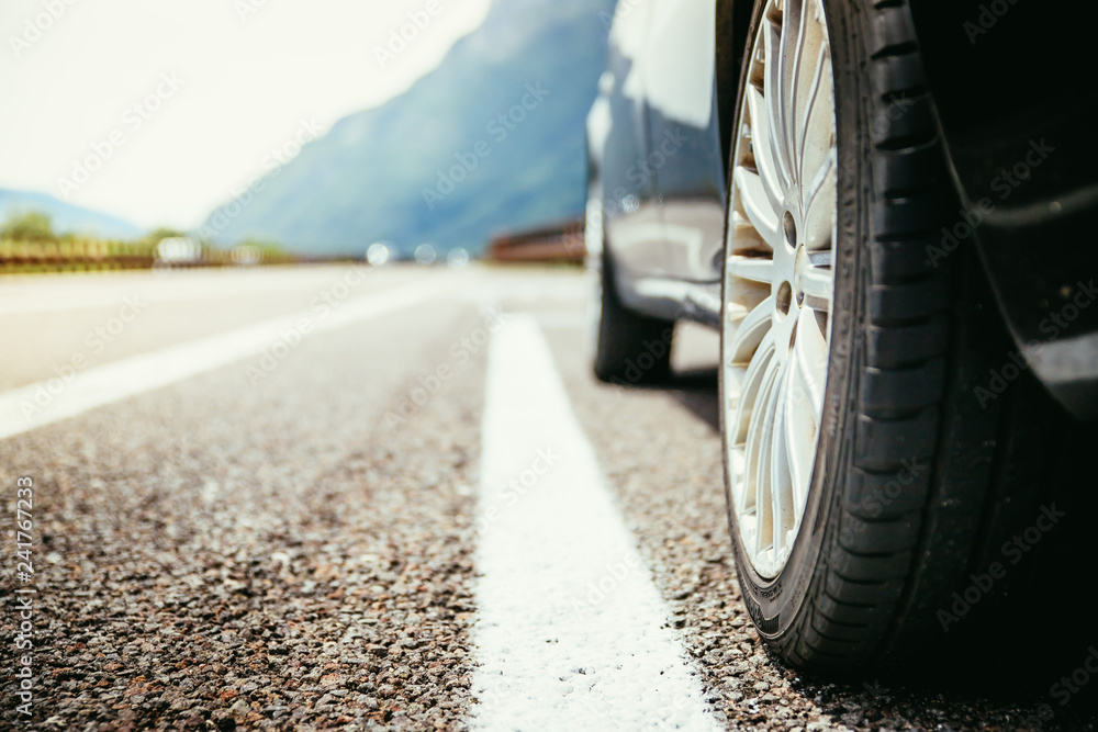 Tyre of a car on the emergency lane, breakdown on the highway. Copy space. Tyre of a car on the emergency lane, breakdown on the highway. Copy space.