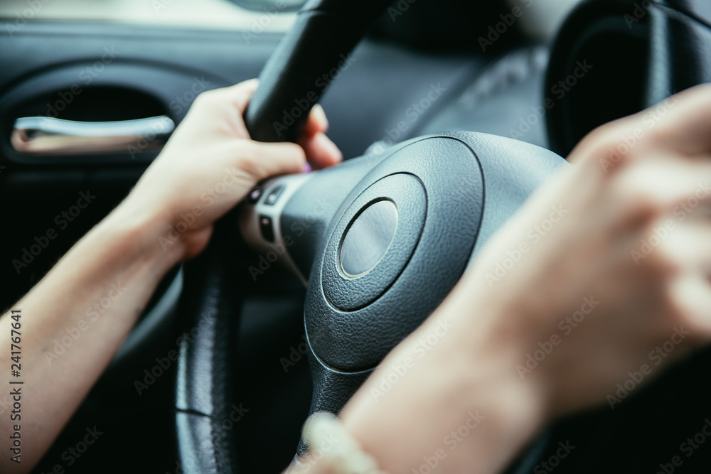 Sports car steering wheel, woman is driving Sports car steering wheel, woman is driving