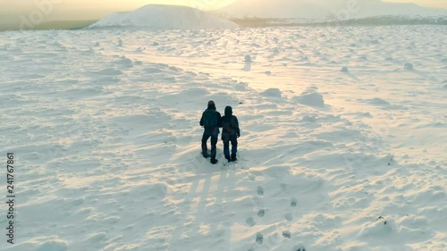 Aerial View Of Man And Woman Couple Hiking Climbing Mountain Slope Winter Vacation. Drone Shot People Mountaineering Winter Snow Landscape. Snow Expedition Explore Peak Concept. photo