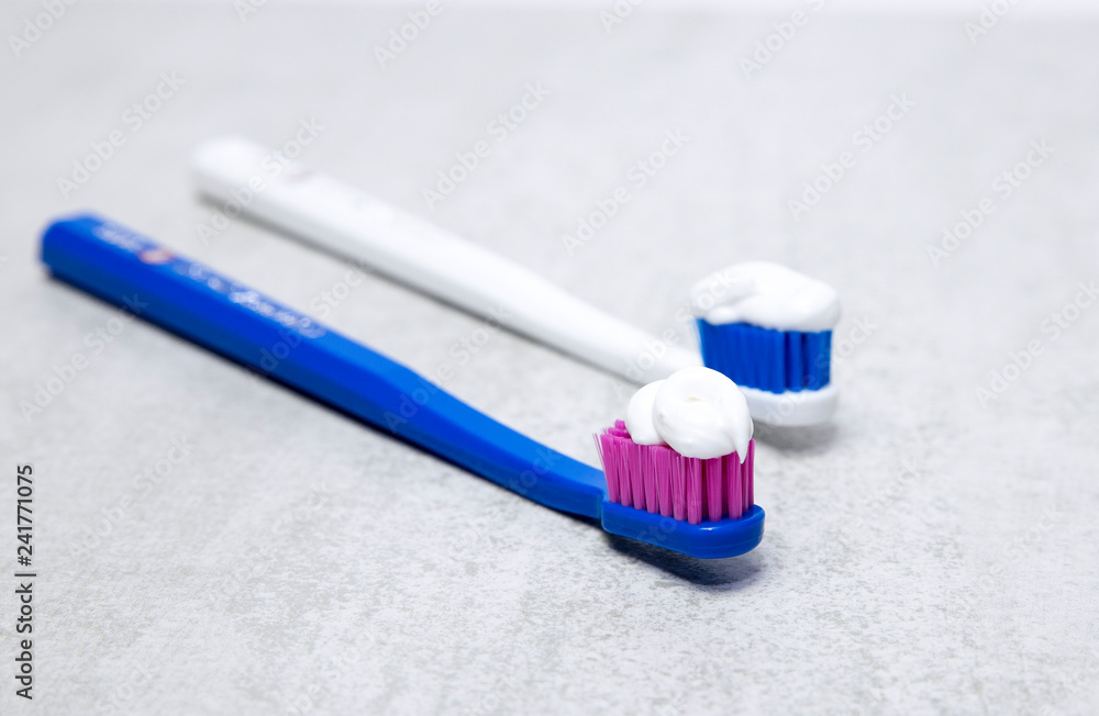 Colorful toothbrushes on a light background - obrazy, fototapety, plakaty 
