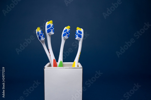 Colorful toothbrushes on a dark background