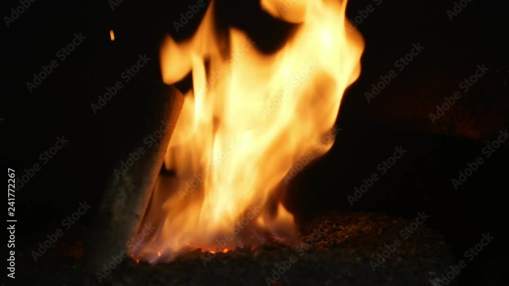 Pellet fire burn with spruce sawdust into the delivery strew bio wooden pallets to industrial modern boiler, sparks fly out and flames fire detail , biofuels made from compressed biomass fuel Pellet fire burn with spruce sawdust into the delivery strew bio wooden pallets to industrial modern boiler, sparks fly out and flames fire detail , biofuels made from compressed biomass fuel