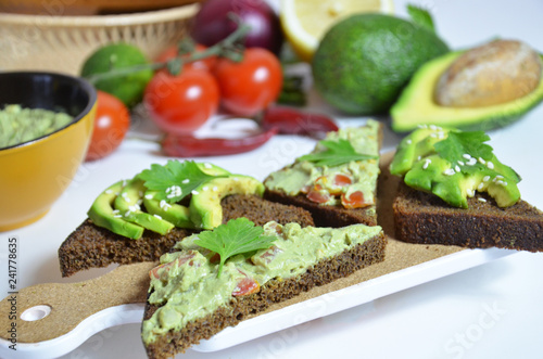 Guacamole and bread. Toast with avocado on white background. Homemade Mexican healthy vegan food