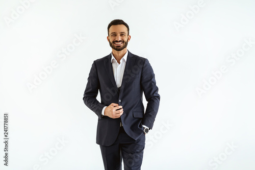 The businessman in a beautiful suit standing on the white background