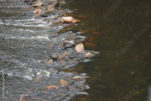 the river flows through a rocky pass, the water of a stream