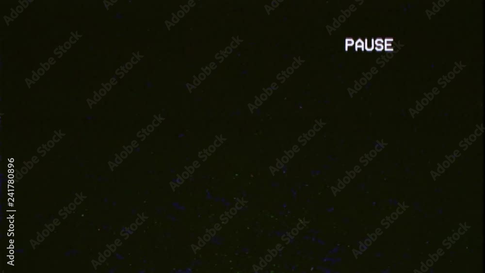 A capture of a VCR playing and pausing a VHS blank tape the text Pause