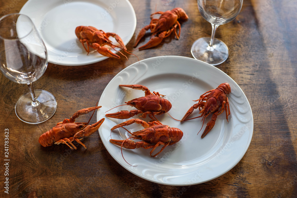 Runaway lobsters on the wooden table Runaway lobsters on the wooden table