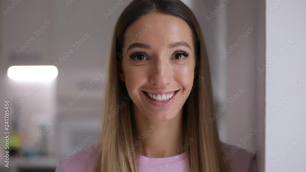 Smiling cute happy woman face closeup at home in slow motion Smiling cute happy woman face closeup at home in slow motion