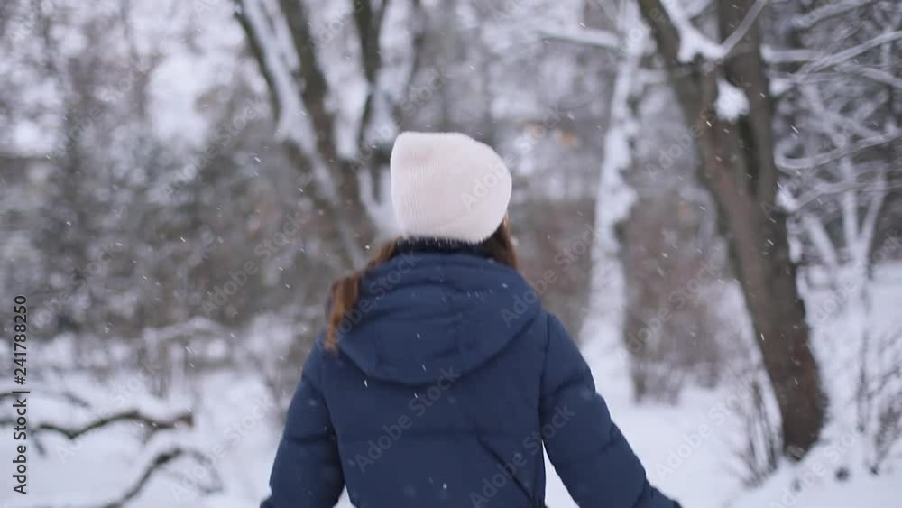 beautiful woman having fun jumps in snowy park beautiful woman having fun jumps in snowy park