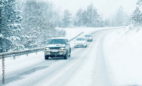 Traffic cars on winter road in snow blizzard © disq
