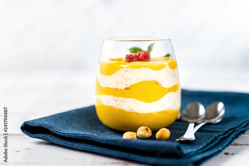 Close up of mango smoothie with yogurt on white table Close up of mango smoothie with yogurt on white table