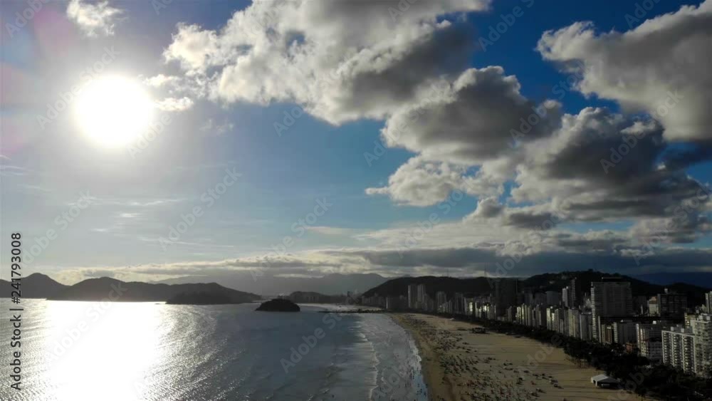 Silhouette Of City Along the Coast With Bright Sun and Clouds- Moving Backwards Silhouette Of City Along the Coast With Bright Sun and Clouds- Moving Backwards