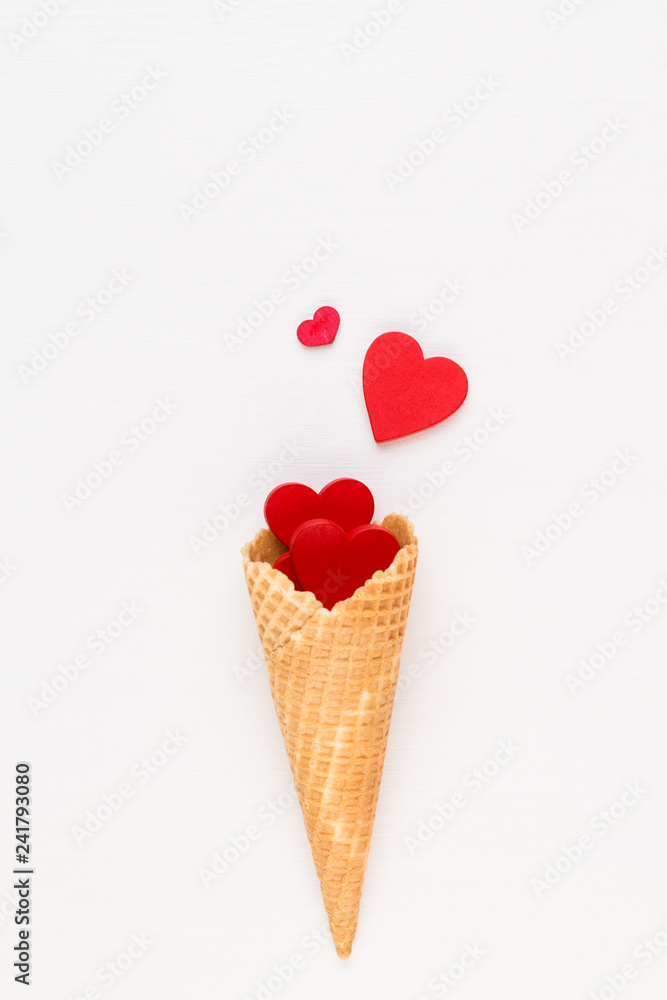 Creative composition for Valentines day with waffle cone, mixed hearts on white background top view. Fashion flat lay. Creative composition for Valentines day with waffle cone, mixed hearts on white background top view. Fashion flat lay.