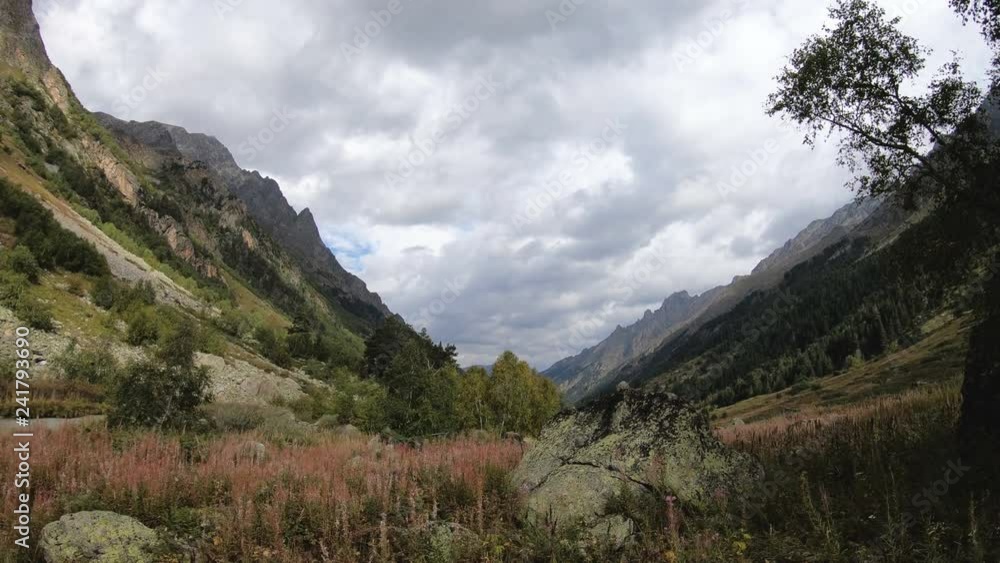 Evening time-lapse in the mountains of Dombai in the North Caucasus before the rain. Gorge with middle forest Evening time-lapse in the mountains of Dombai in the North Caucasus before the rain. Gorge with middle forest