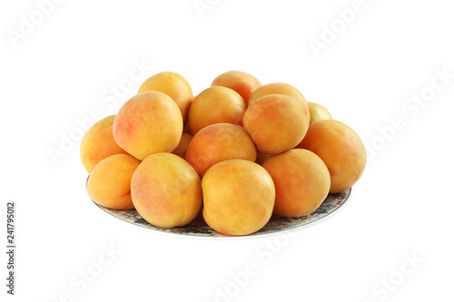 Ripe apricots on white plate isolated on white background