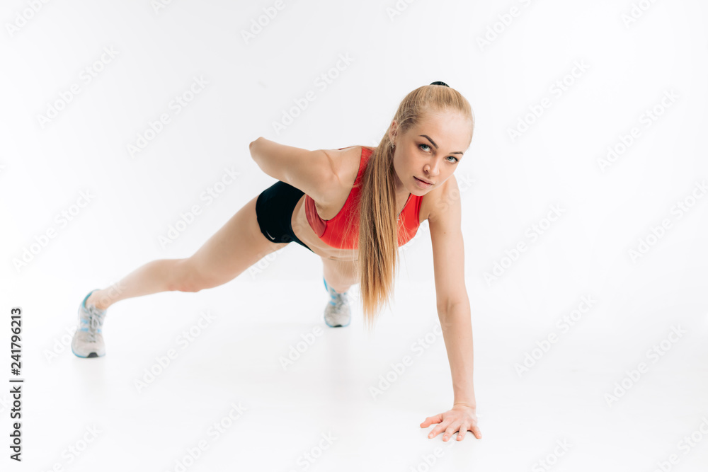 young awesome blond sportswoman is leaning on one hand and pressing up on the floor. wellness. wellbeing, active life. motivation , spare time young awesome blond sportswoman is leaning on one hand and pressing up on the floor. wellness. wellbeing, active life. motivation , spare time