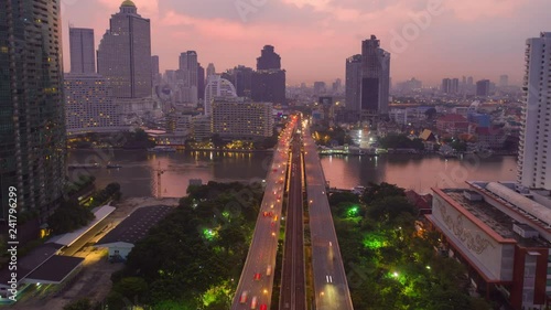 Motion Time lapse, Hyperlapse of Fly over business center of Bangkok, Sathon thaksin bridge chaophraya river scene photo