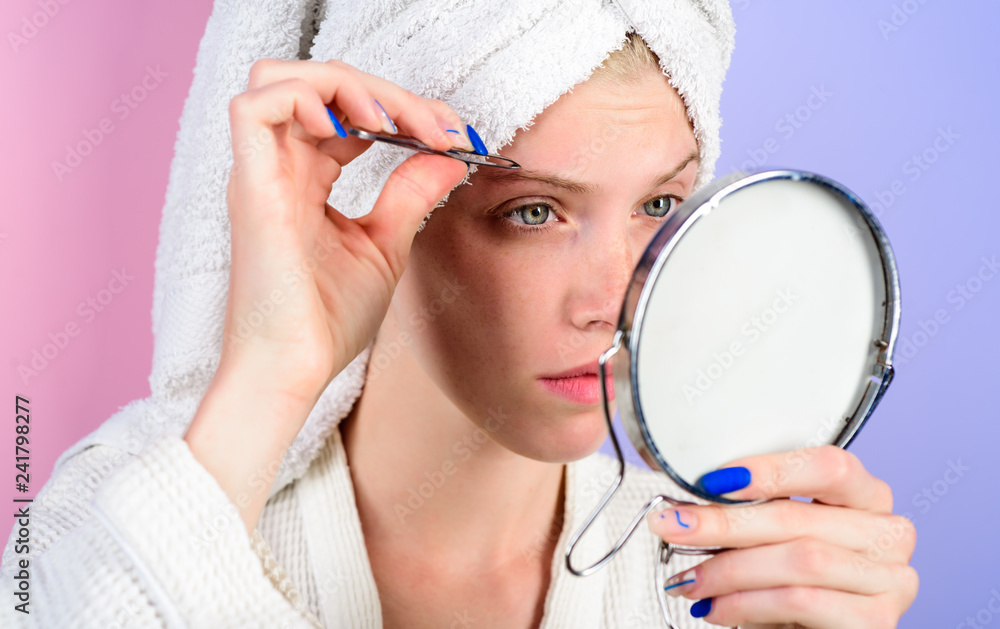 Woman pluck eyebrows looking in mirror. Epilate eyebrows. Woman pulls out  eyebrows with tweezers. Girl makeup process. Eyebrows beauty care concept.  Beauty tools. Correction procedure in beauty salon. Stock Photo | Adobe