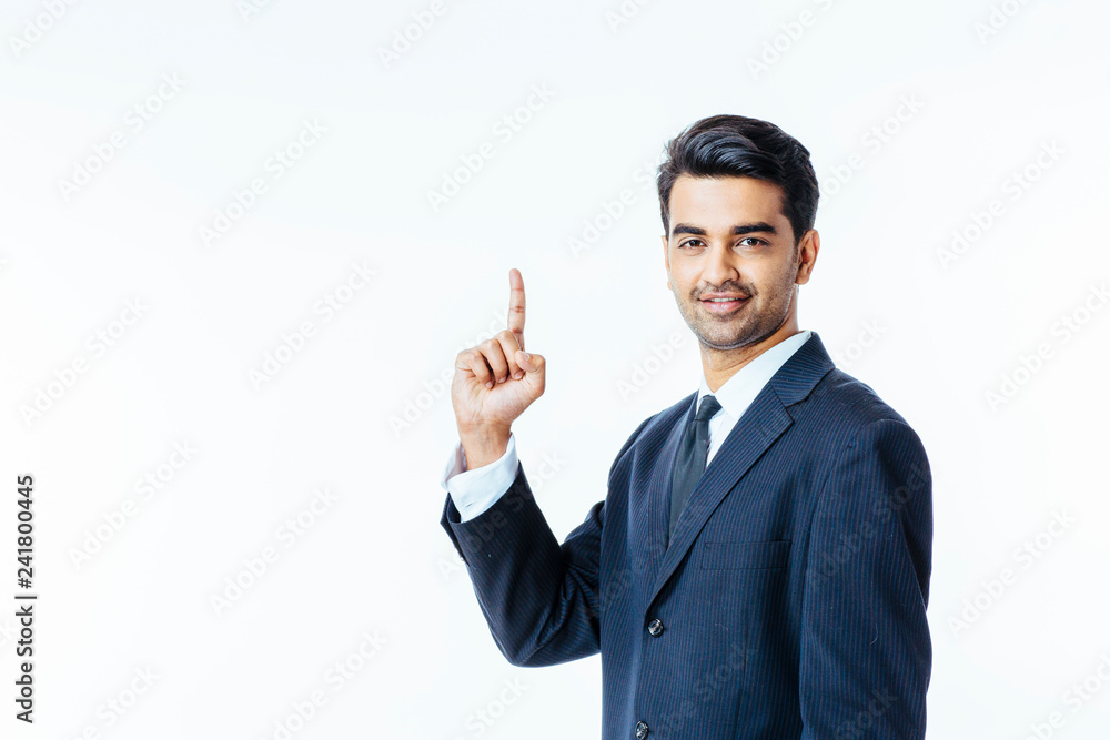 Portrait of a handsome man in business suit and tie pointing up and looking at camera, isolated on white studio background Portrait of a handsome man in business suit and tie pointing up and looking at camera, isolated on white studio background