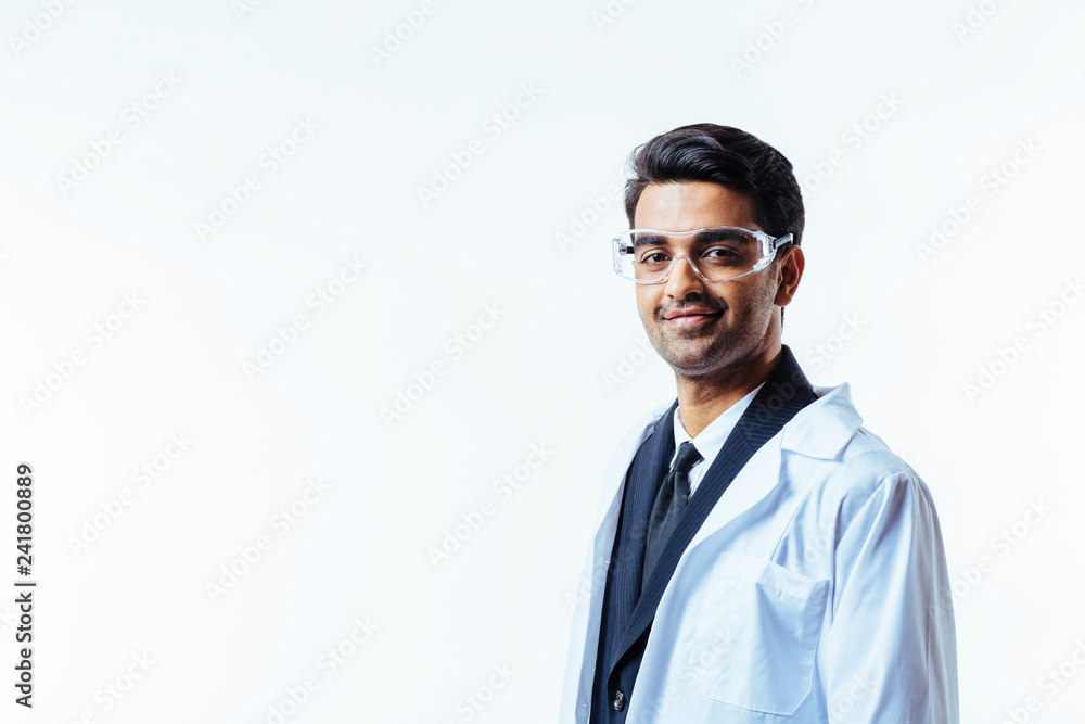 Portrait of a man in business suit, lab coat and protective glasses, looking at camera, isolated on white studio background Portrait of a man in business suit, lab coat and protective glasses, looking at camera, isolated on white studio background